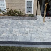 Paver patio with a dark border.